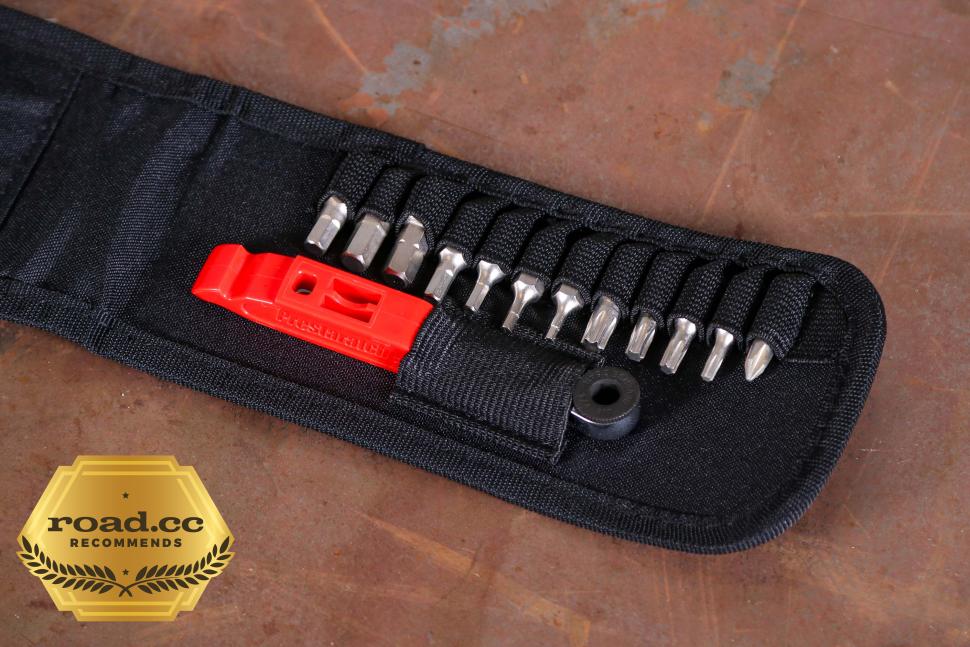 The Prestaratchet GO Wallet - 6 Function Multi-tool includes a black fabric tool roll, metal screwdriver bits, a reversible ratchet, and a red Prestalever tire lever. A road.cc gold badge is in the lower left corner on a brown surface.