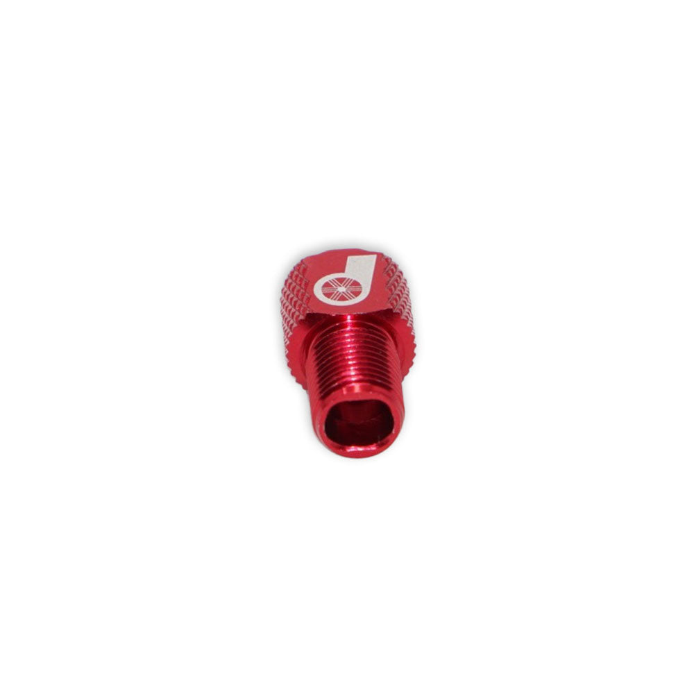 The Prestadapter TUBELESS is a red lightweight alloy adapter with a threaded end, serving as a Schrader to Presta valve adapter and valve core remover for bike tires, shown against a white background.