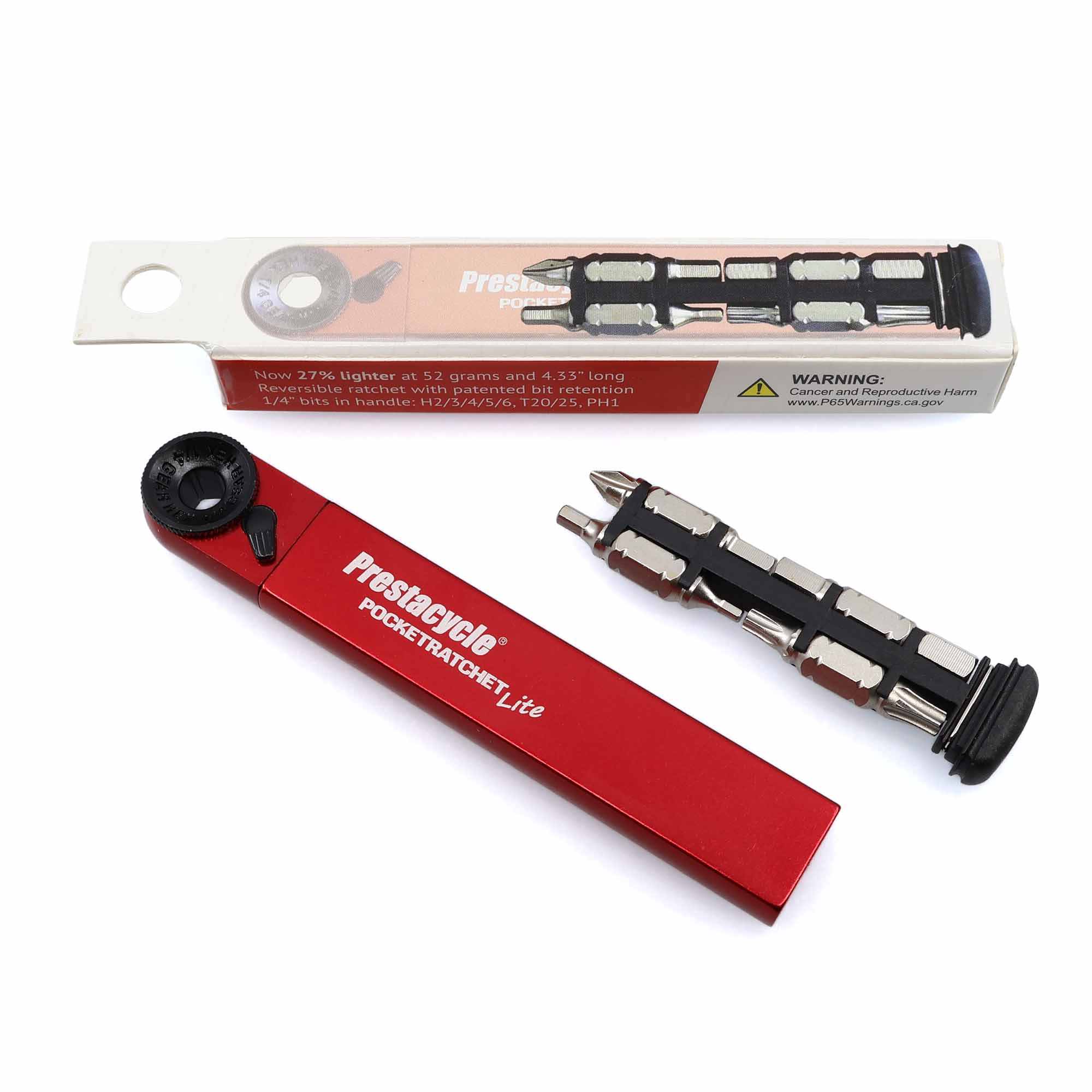 A red Prestacycle PocketRatchet Lite - Pocket Multi-tool w/Bits stored in handle is shown next to its white packaging with product info and a yellow warning label, as well as a bit holder containing multiple metal bits.