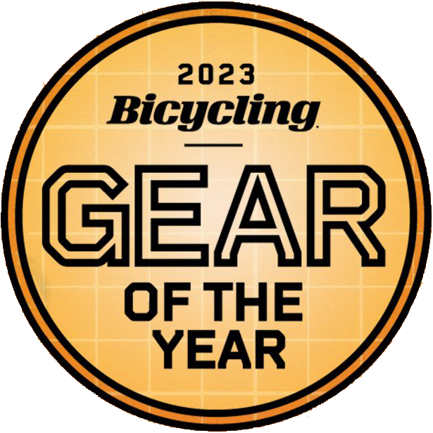 A round orange badge with a grid pattern and bold black text, 2023 Bicycling GEAR OF THE YEAR, celebrates innovations like the Prestaratchet GO Wallet - 6 Function Multi-tool featuring a reversible ratchet.