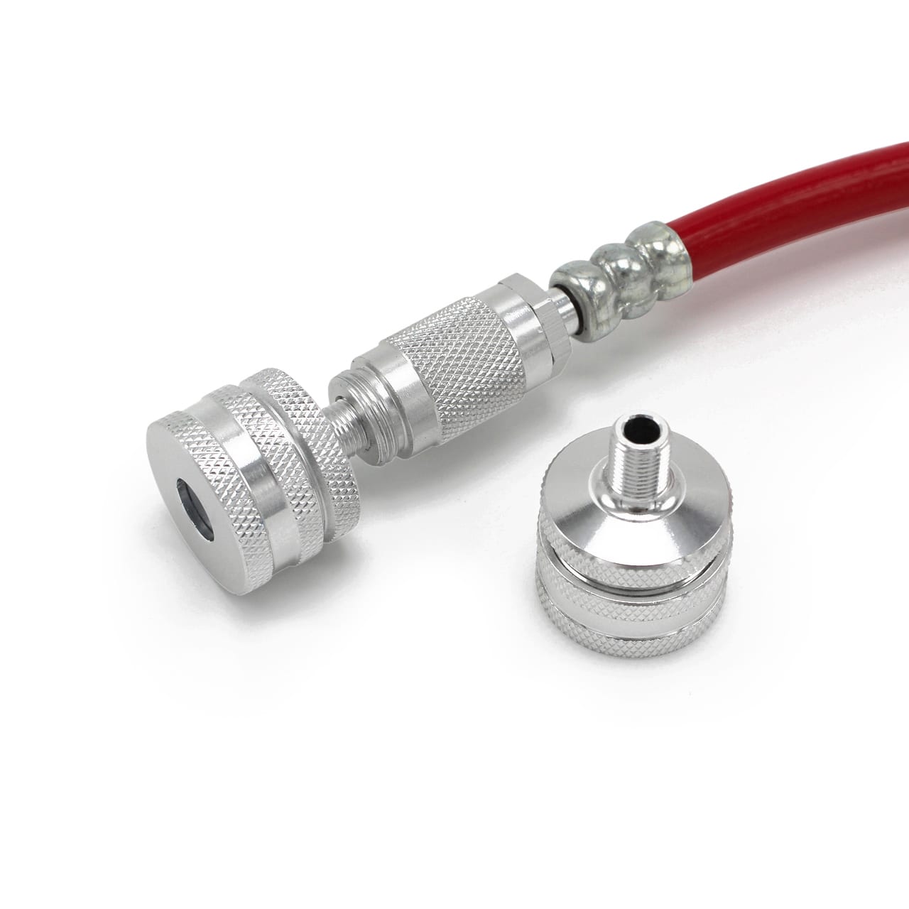 The Prestacycle Big Presta Head features a red hose with a silver connector, cylindrical metal fitting, and knurled grips. It has threaded openings for Presta valve compatibility and is shown beside a similar floor pump accessory against a white background.
