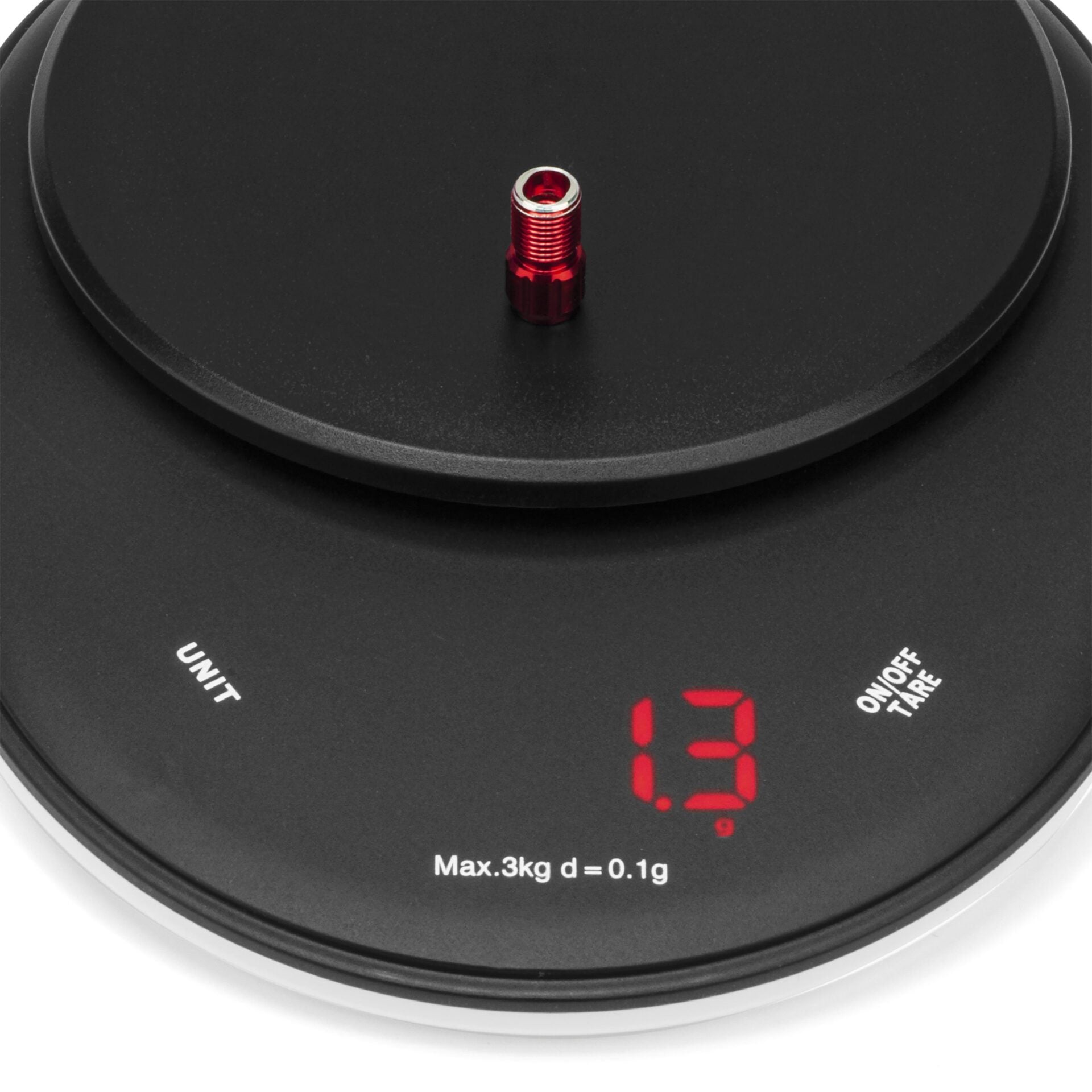 A Prestacycle Prestadapter Schrader to Presta adapter / Valve Core Tool, small and cylindrical in red metal, rests on a black digital scale showing 1 gram in red numbers with UNIT and ON/OFF TARE buttons.