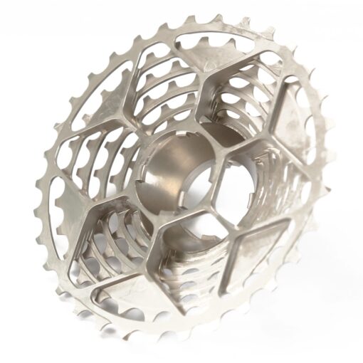 A silver Prestacycle UniBlock PRO Cassette (12 Speed) for Campagnolo featuring a hollow, lightweight, geometric design with detailed cutouts and teeth, shown from an angle to emphasize its intricate craftsmanship.