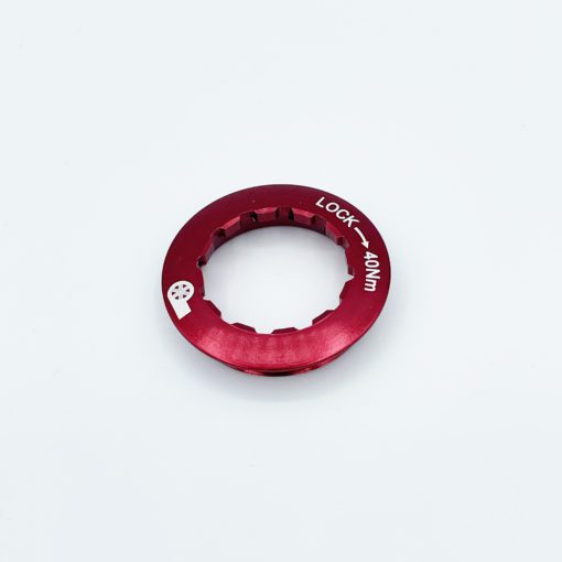A red metal lockring with notched edges, made from durable chromoly steel and labeled LOCK – 40Nm in white text, is shown on a white background—designed for the Prestacycle UniBlock PRO Cassette (10 Speed) (Campagnolo).