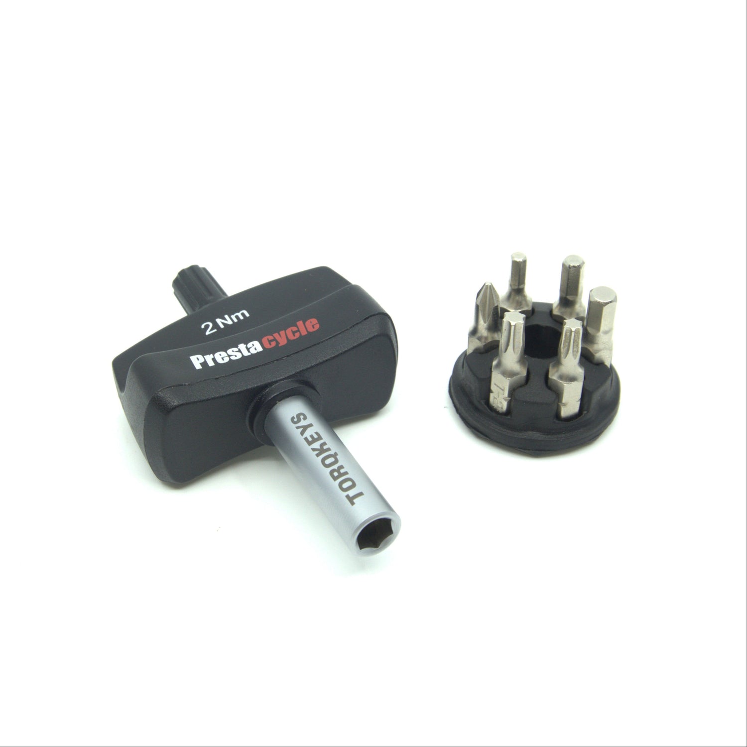 The Prestacycle Mini TorqKeys 2Nm Preset Torque Tool, shown with a handle, detachable round holder, and six interchangeable bits, is displayed on a white background.