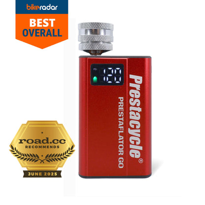 A red Prestaflator GO - Portable Digital Rechargeable Preset Bicycle Tyre Inflator with digital display is shown, featuring a Best Overall badge from BikeRadar and a road.cc Recommends June 2025 gold award badge.