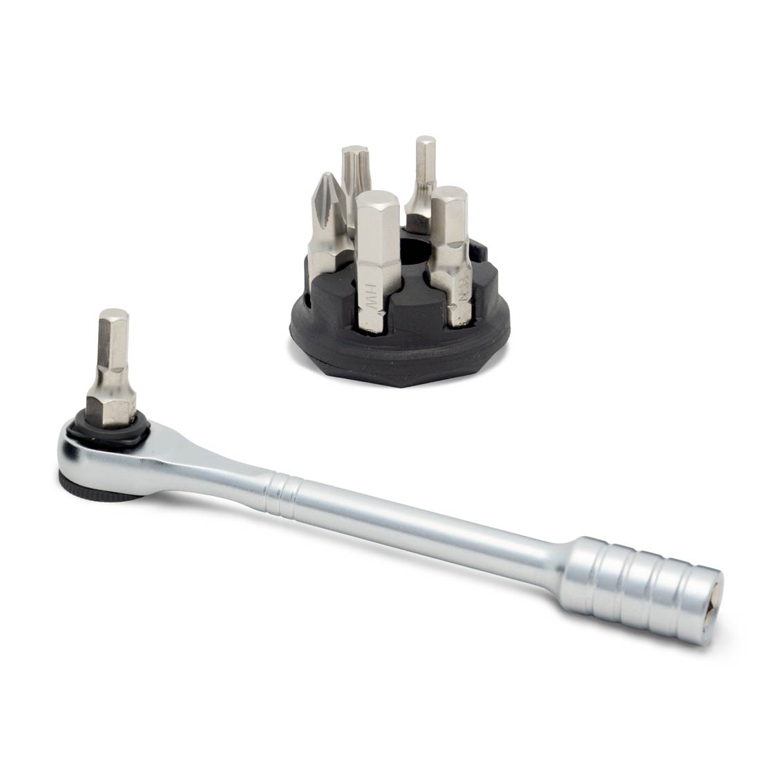 The Prestaratchet Micro – Kit with six S2 bits and a round holder stand is shown on a white background, with the metal ratchet wrench in front of the black holder.