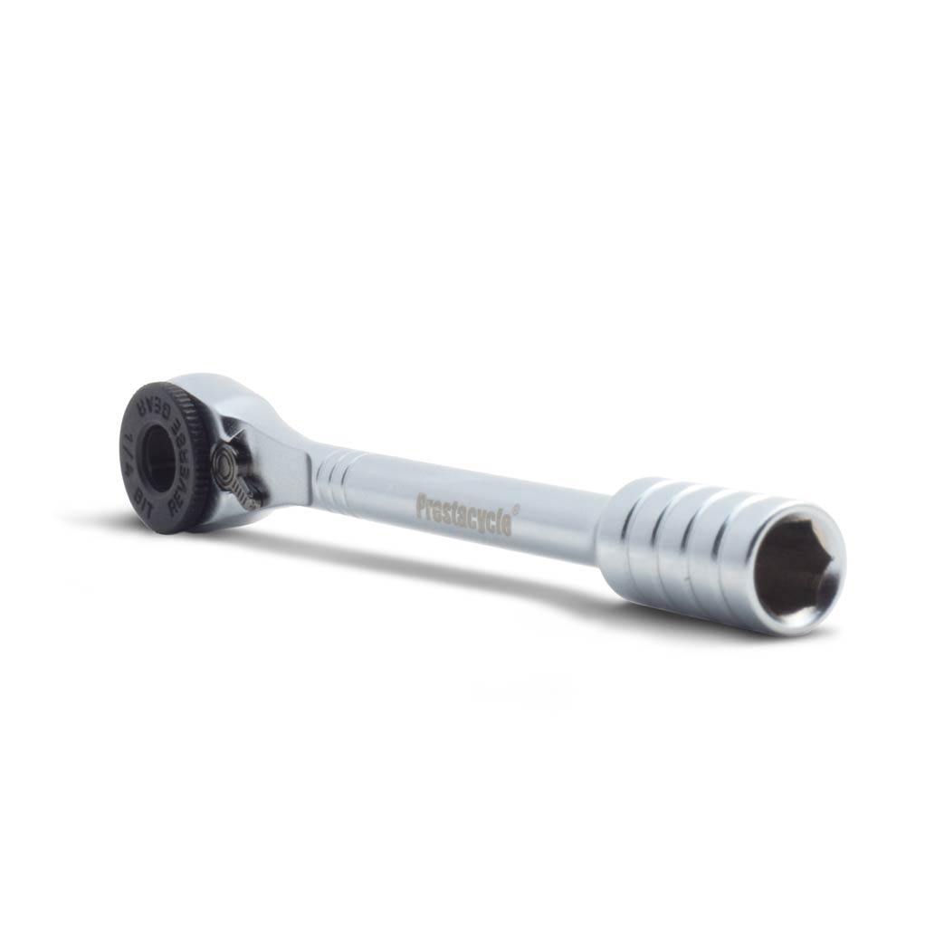 The Prestaratchet Micro Kit, featuring a chrome micro pocket ratchet wrench with a textured handle, round gear mechanism, six S2 bits, and a round holder stand, photographed on a white background.