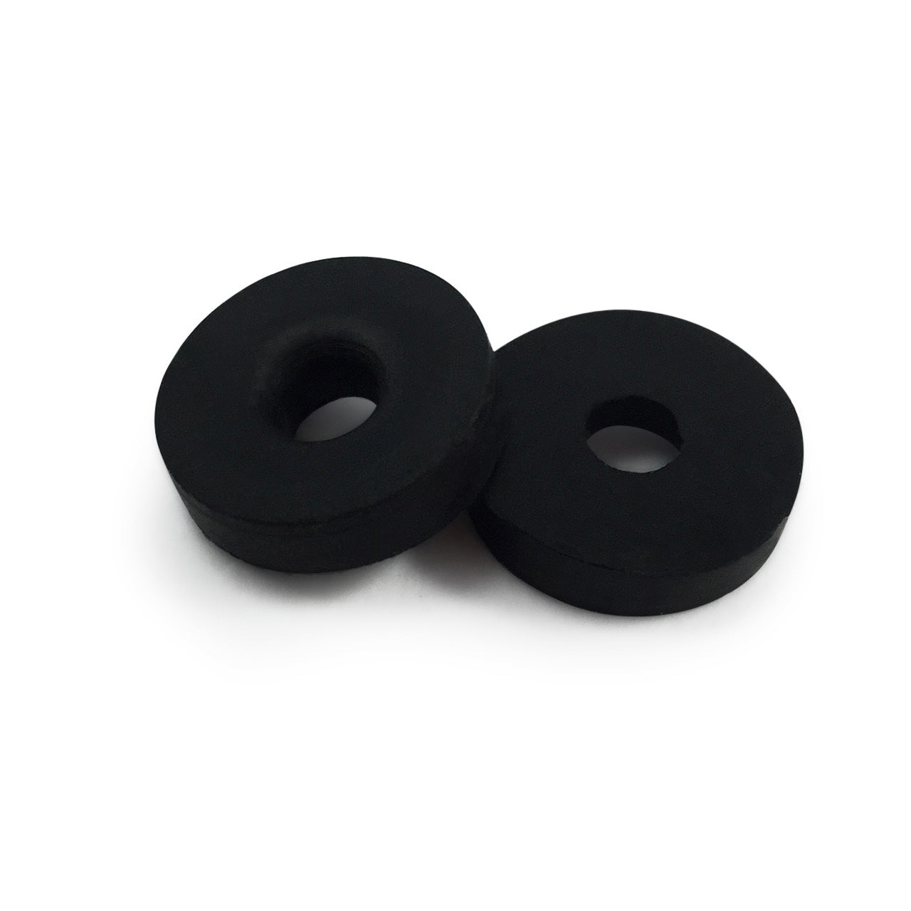 Two Prestacycle Prestaflator Mini Presta Head Gaskets, black rubber washers with central holes, are placed on a white background, one slightly overlapping the other.