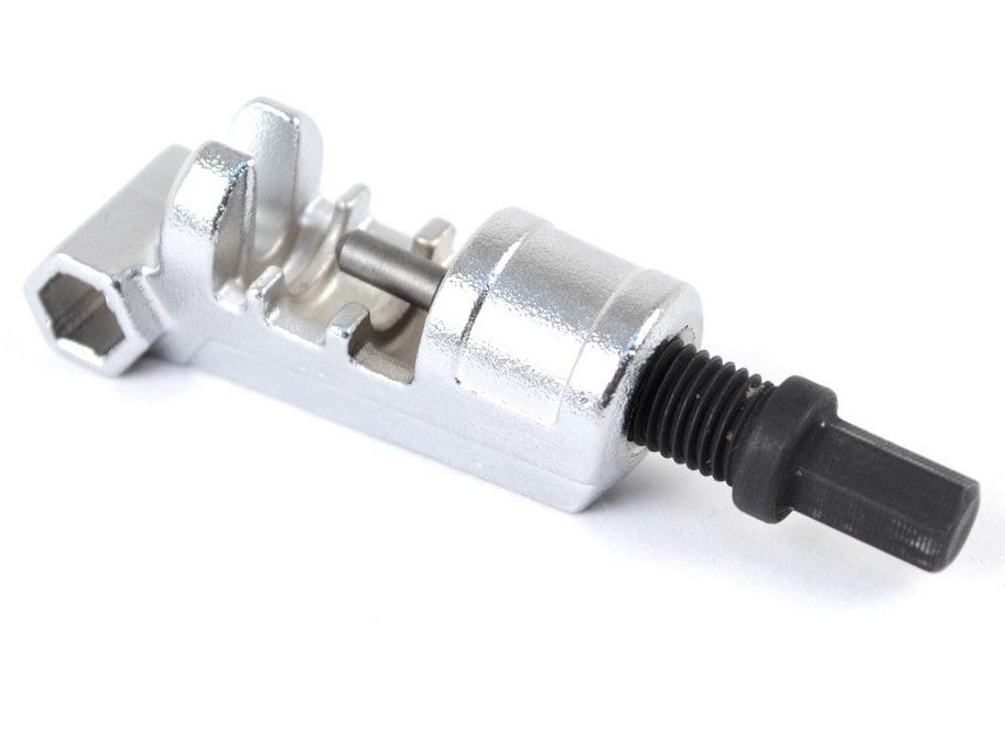 The PrestaRatchet Chain Accessory is a compact tool with a silver body and black threaded handle, perfect for removing or inserting chain pins on bicycles or motorcycles.