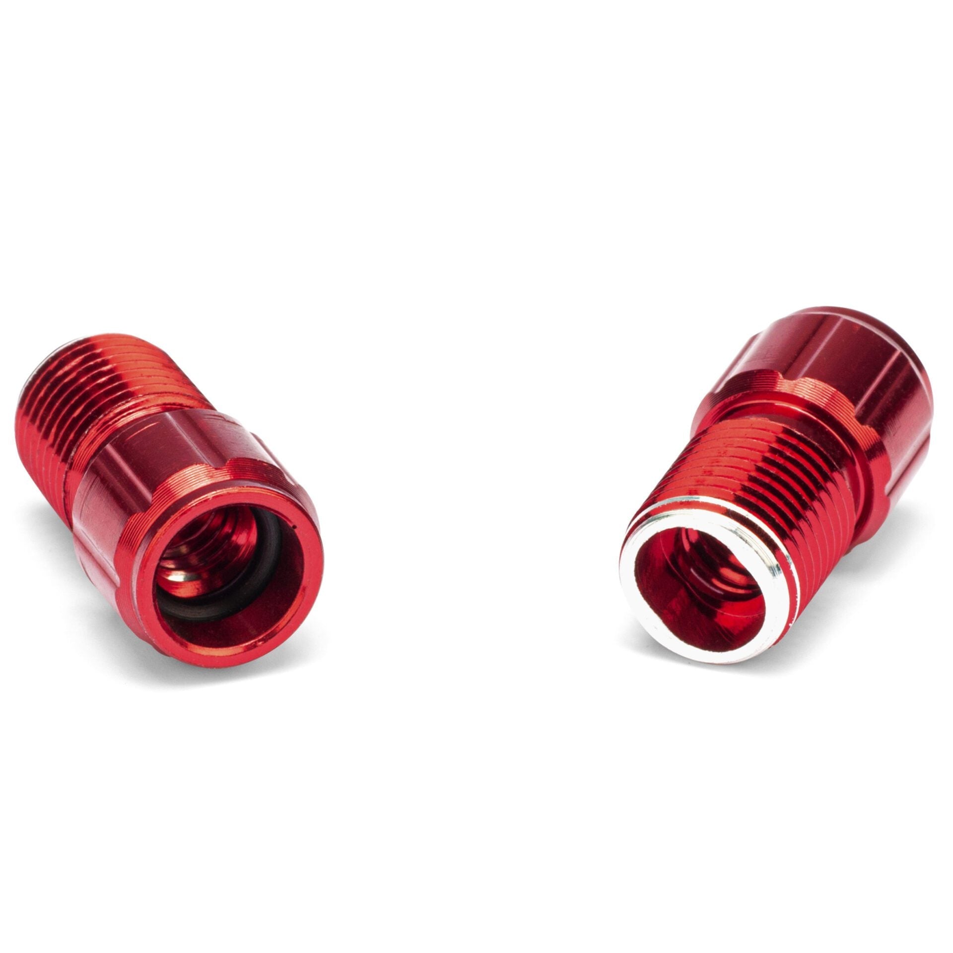 Two Prestacycle Prestadapter Schrader to Presta adapters are shown side by side on a white background, one facing up and one down, displaying both inner and outer threads of the red metal alloy fittings.