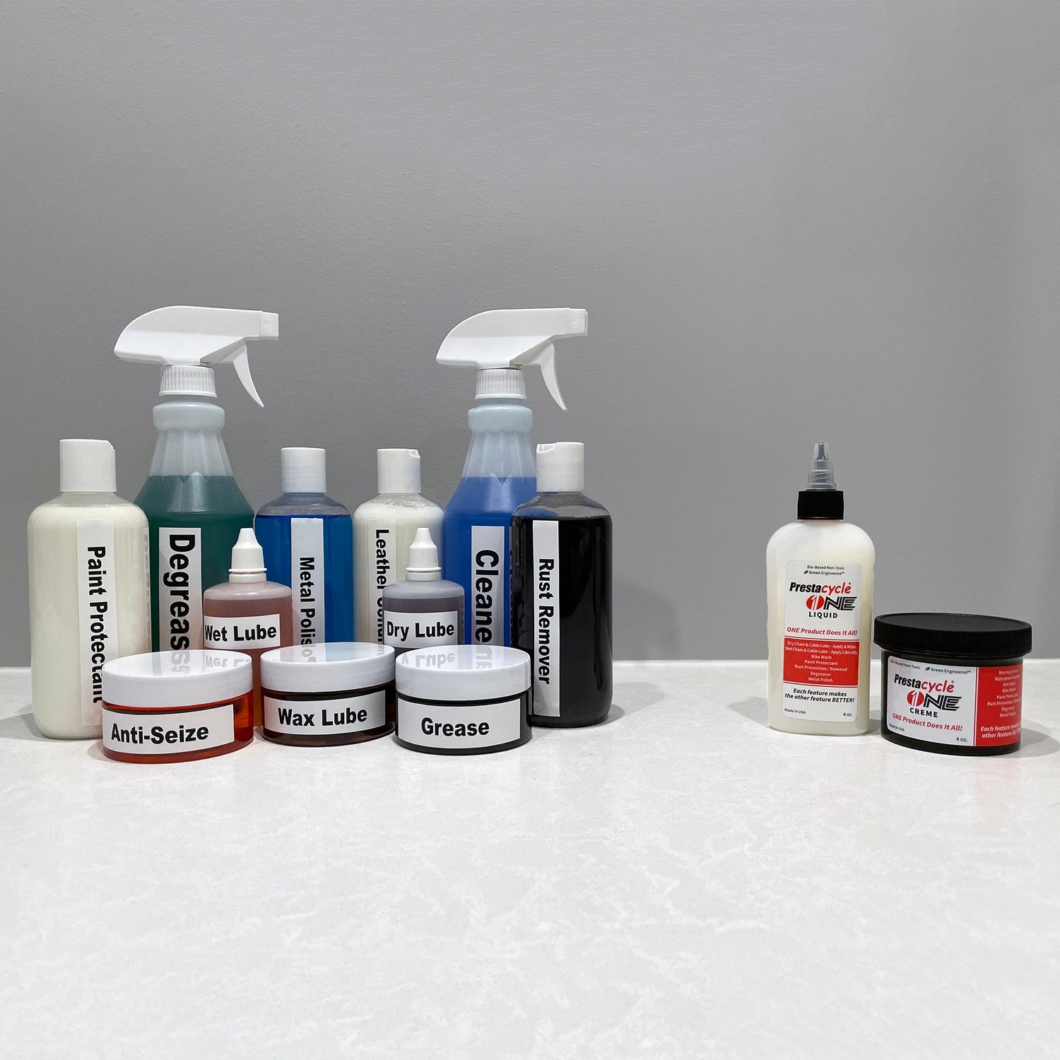 Prestacycle One Cream, a bike maintenance product, is neatly arranged on a white countertop.